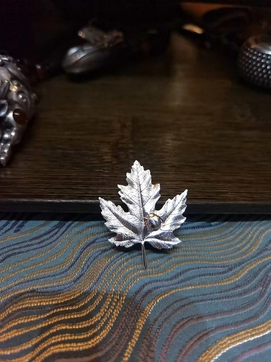 Silver water filter fish and mapple leaves
